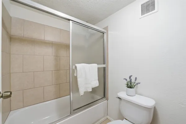 a bathroom with a shower and a toilet