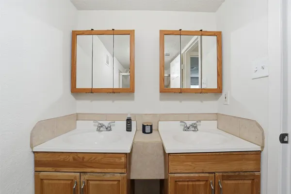 a utility room with two sink and a mirror