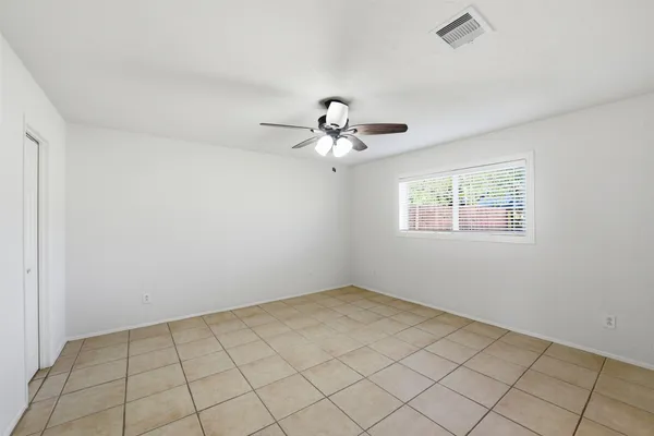 a view of an empty room with a fan