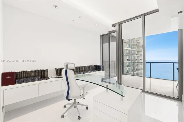 a living room with furniture and large windows