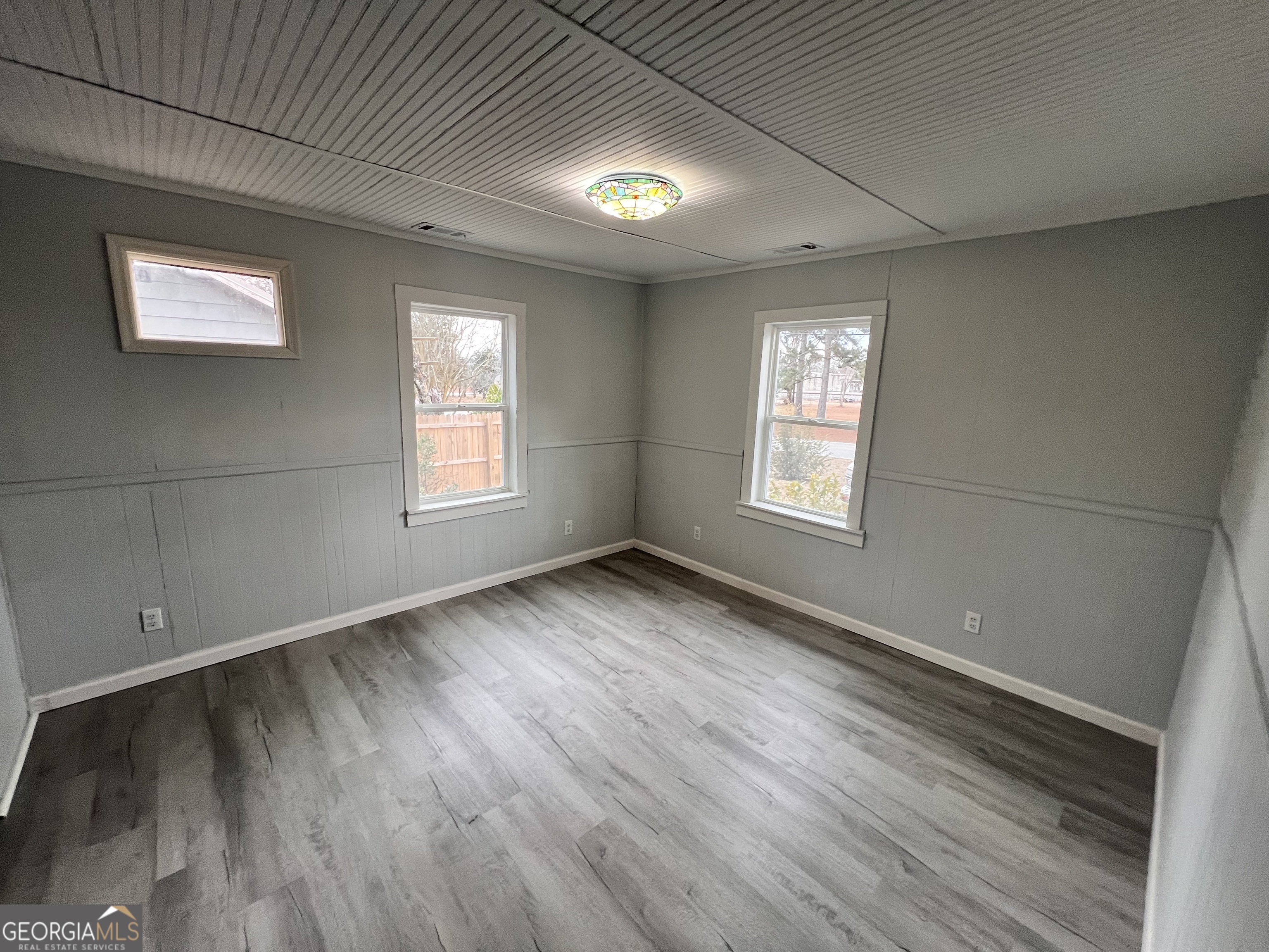 3 9th Street McRae-Helena, GA 31037 - Photo 13 of 19 an empty room with wooden floor and windows