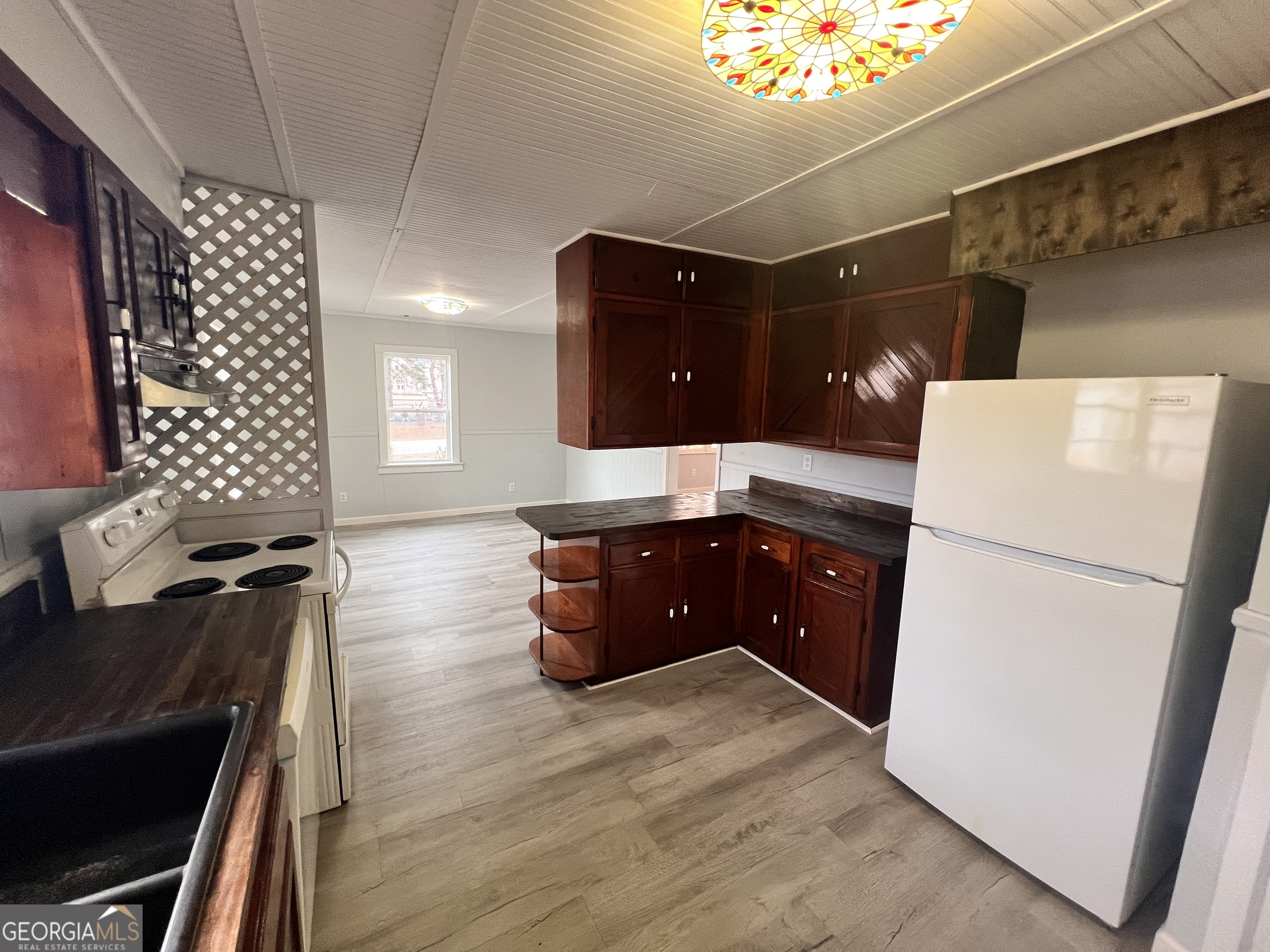 3 9th Street McRae-Helena, GA 31037 - Photo 14 of 19 a kitchen with a refrigerator and a stove top oven