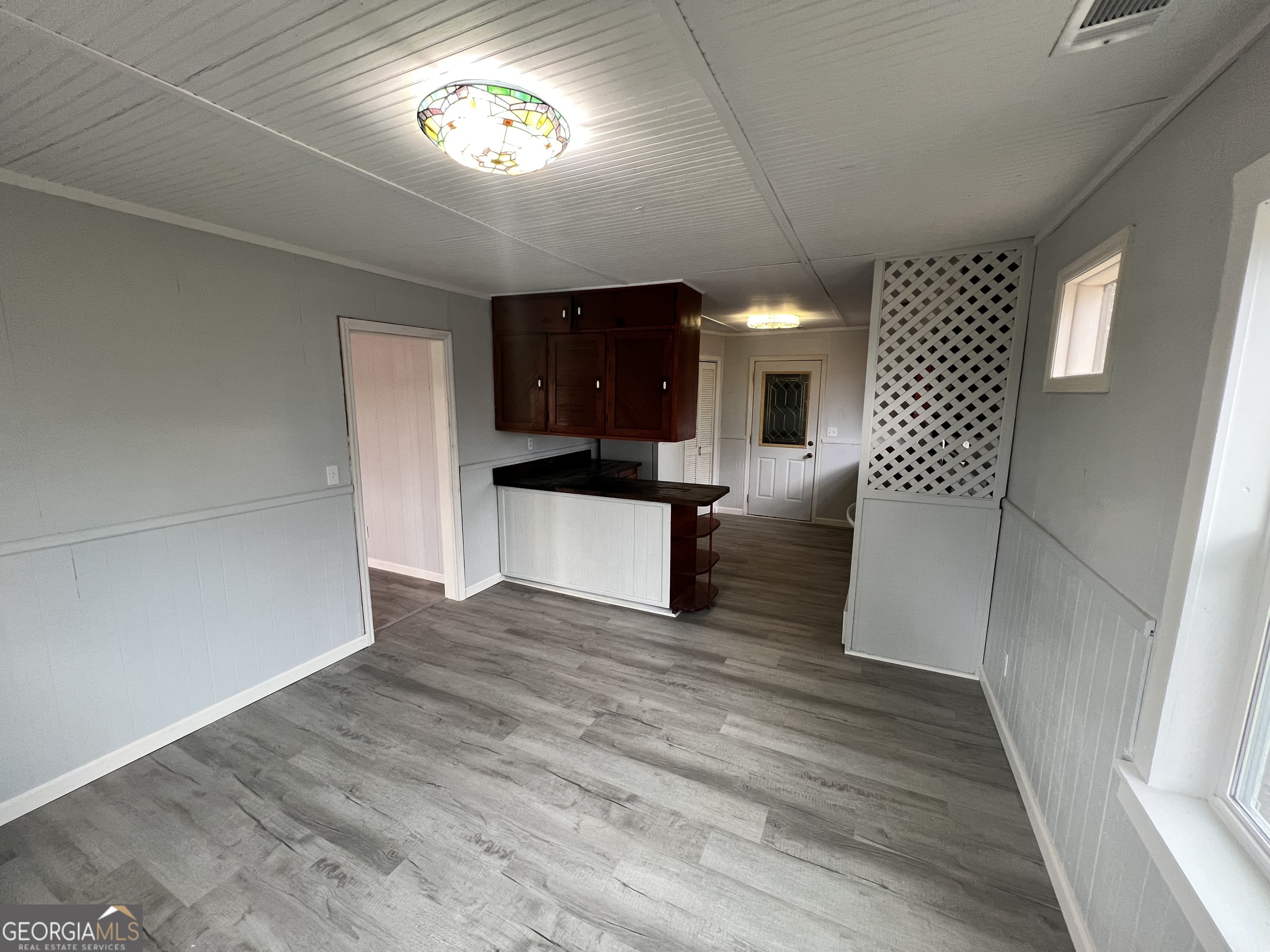 3 9th Street McRae-Helena, GA 31037 - Photo 16 of 19 a view of a hallway with wooden floor and a kitchen space