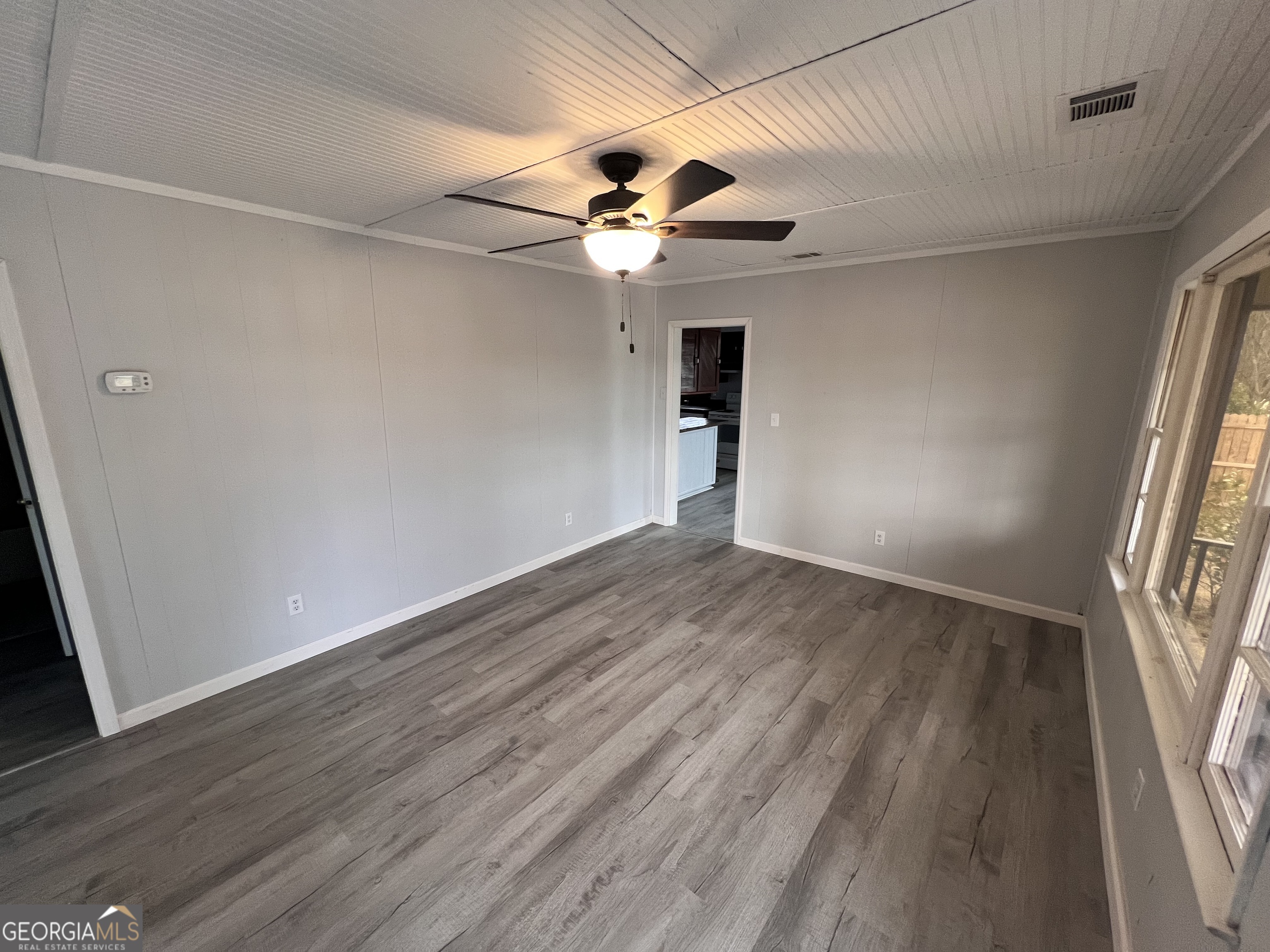 3 9th Street McRae-Helena, GA 31037 - Photo 6 of 19 wooden floor in an empty room with a window