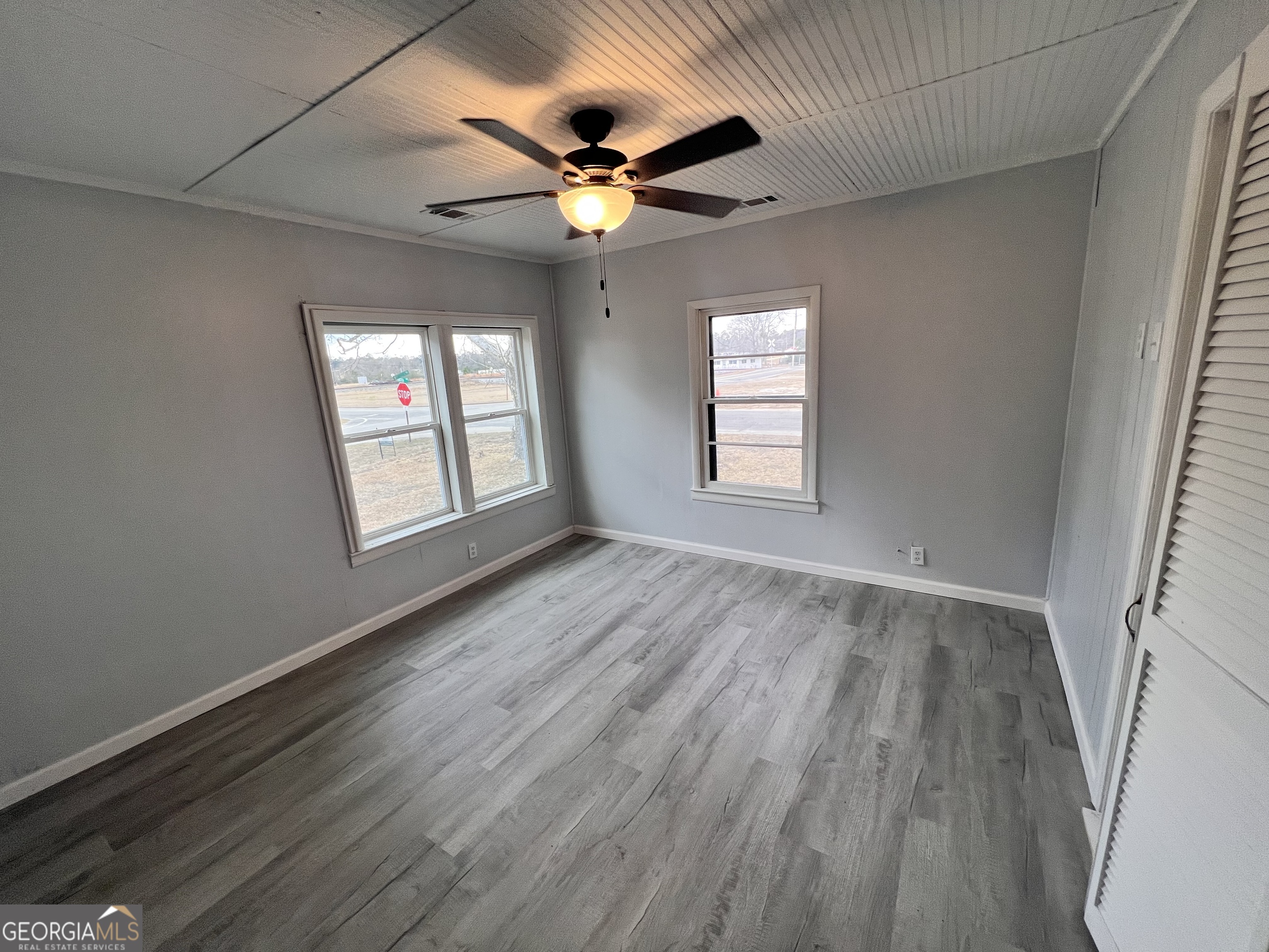 3 9th Street McRae-Helena, GA 31037 - Photo 7 of 19 an empty room with wooden floor chandelier fan and windows