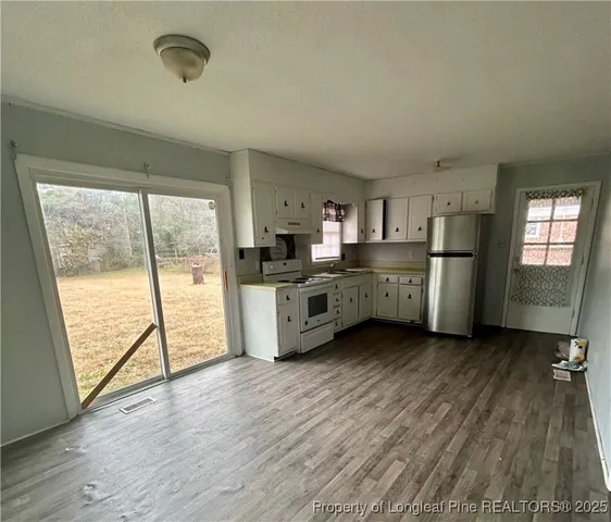 a kitchen with stainless steel appliances a stove top oven a sink and cabinets
