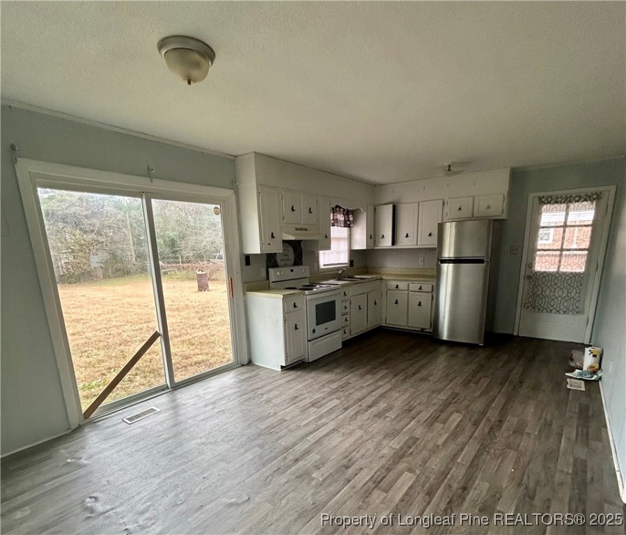 507 Oakdale Gin Road Raeford, NC 28376 - Photo 5 of 16 a kitchen with stainless steel appliances a stove top oven a sink and cabinets