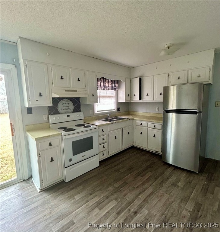 507 Oakdale Gin Road Raeford, NC 28376 - Photo 6 of 16 a kitchen with white cabinets white stainless steel appliances and sink