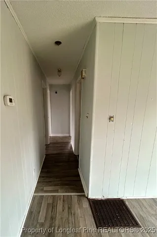 a view of a closet area with hardwood floor
