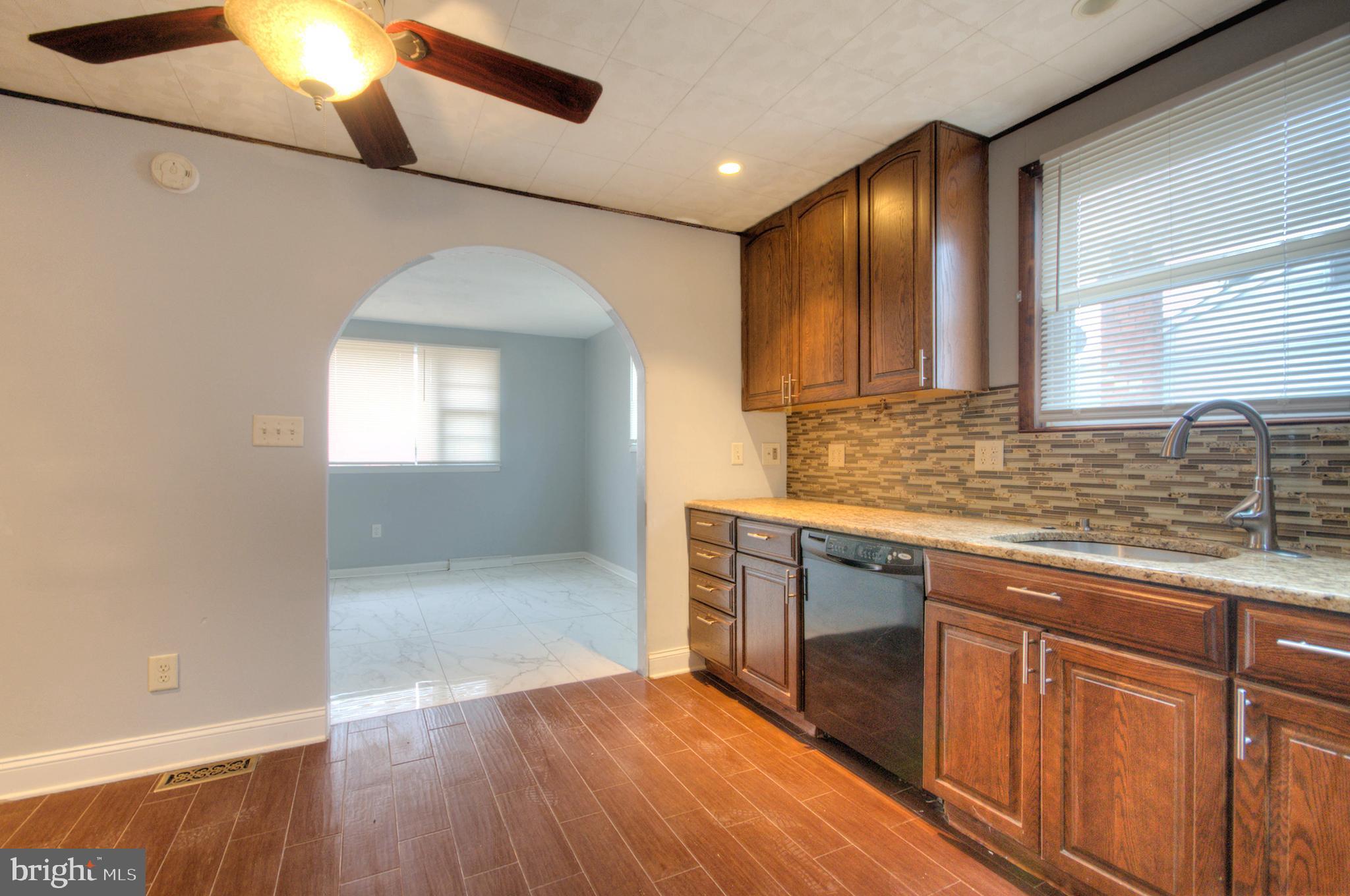32 Fairmount Avenue Lindenwold, NJ 08021 - Photo 12 of 37 a kitchen with granite countertop a stove a sink and a refrigerator