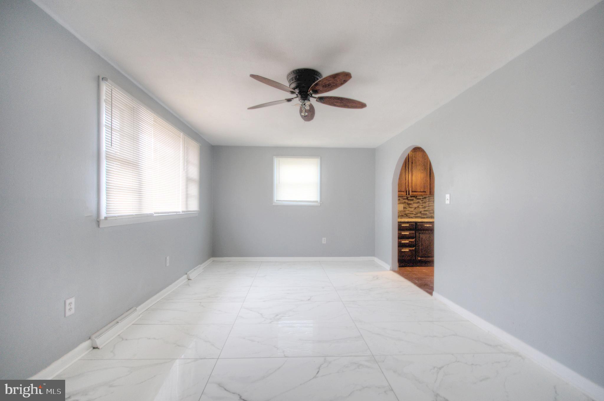 32 Fairmount Avenue Lindenwold, NJ 08021 - Photo 6 of 37 an empty room with windows and ceiling fan