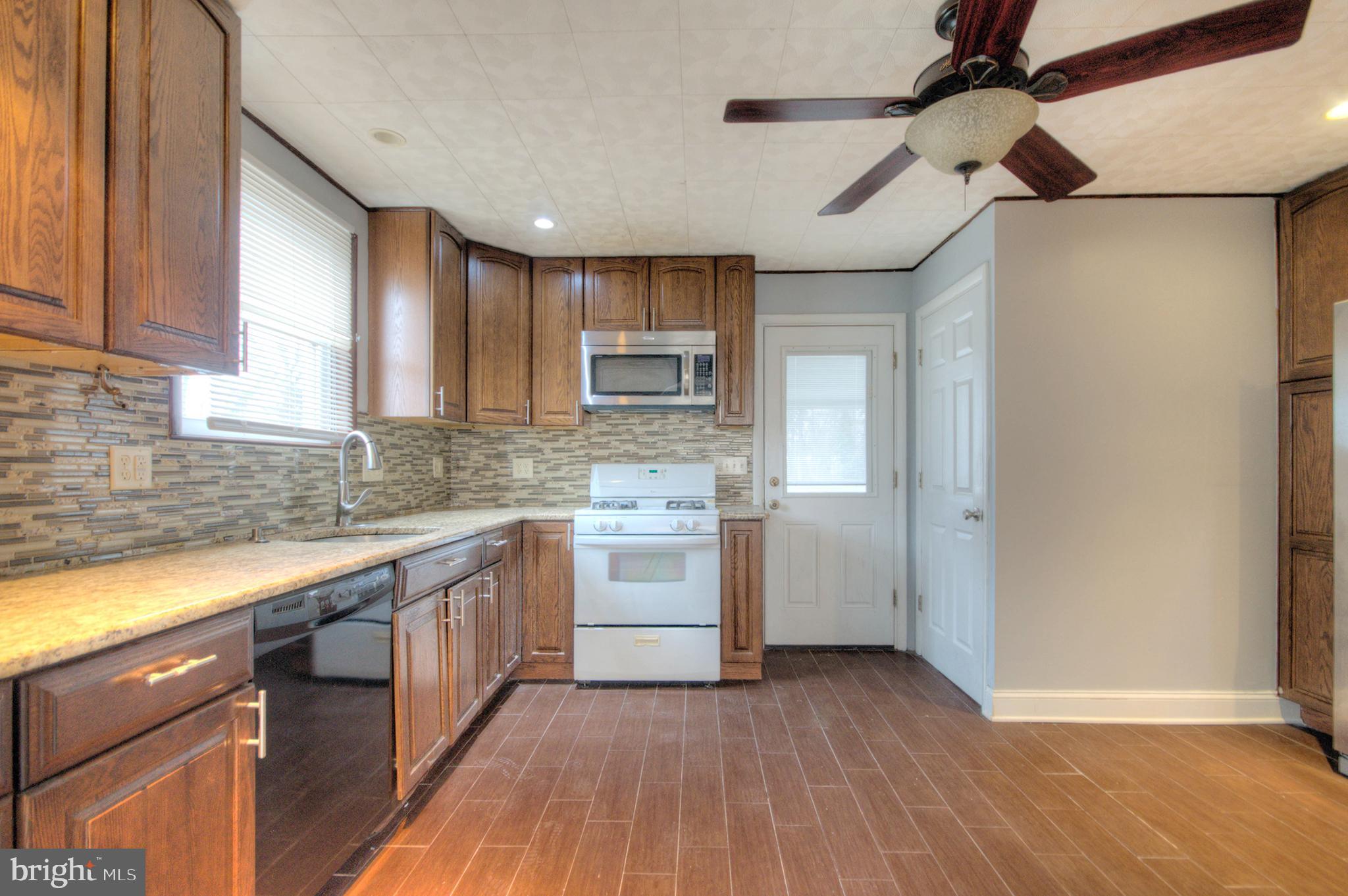 32 Fairmount Avenue Lindenwold, NJ 08021 - Photo 9 of 37 a kitchen with a sink cabinets stainless steel appliances and a window