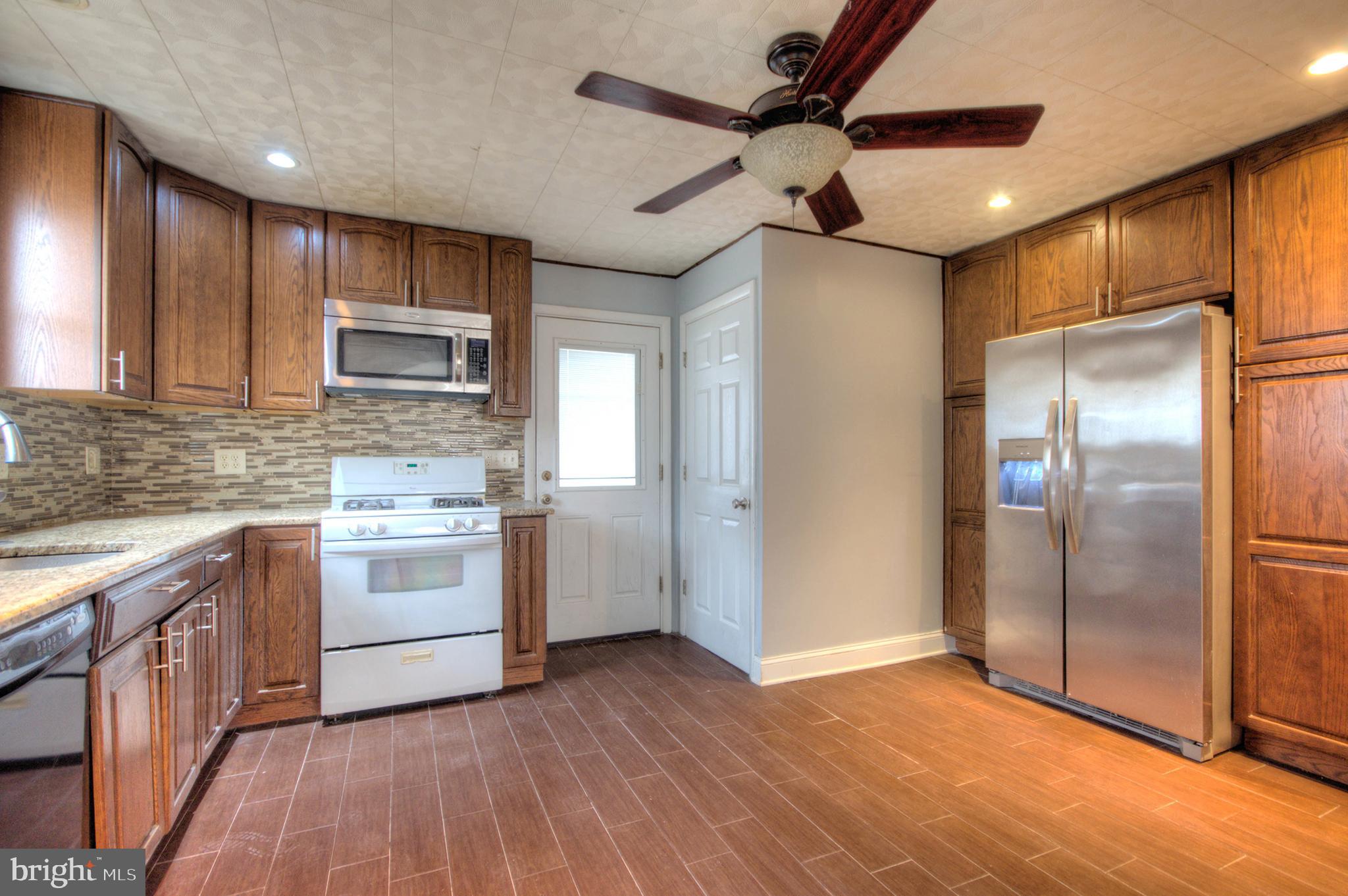 32 Fairmount Avenue Lindenwold, NJ 08021 - Photo 10 of 37 a kitchen with stainless steel appliances kitchen island granite countertop a refrigerator and a stove top oven