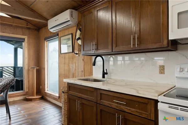 a kitchen with granite countertop stainless steel appliances and wooden cabinets