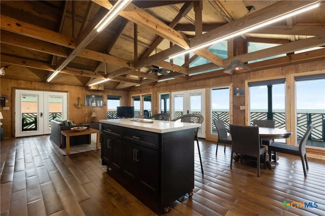 a view of a dining room with furniture wooden floor and chandelier