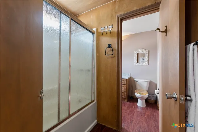 a bathroom with a shower and a toilet