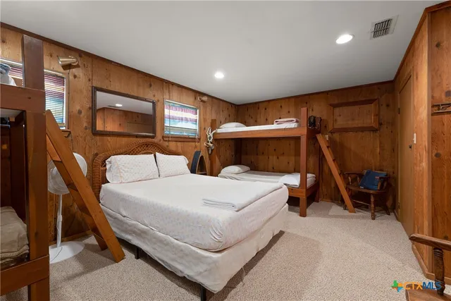 a bedroom with a bed and a chair