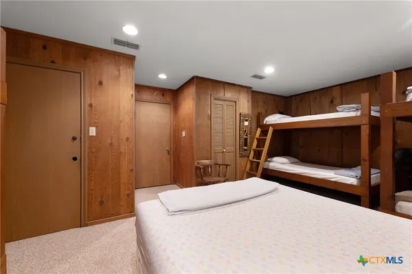 a bedroom with a bed and a television