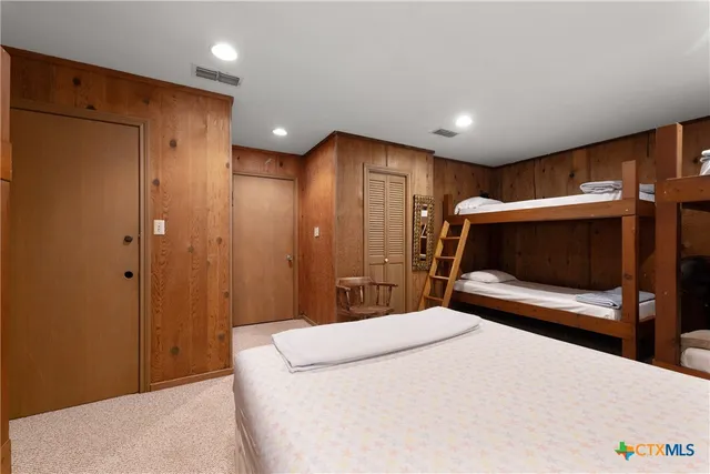 a bedroom with a bed and a television