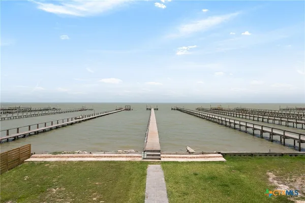 a view of a water with lawn chairs