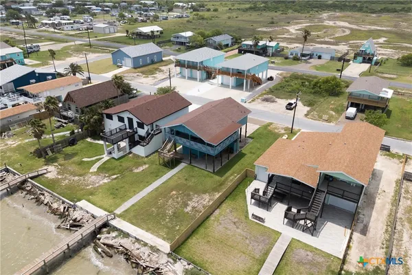 an aerial view of a houses with a lake view