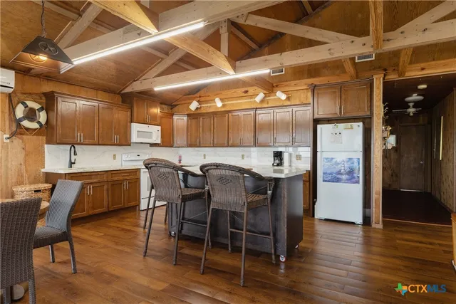 a large kitchen with a table and chairs