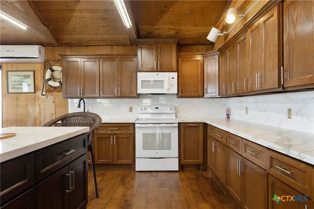 a kitchen with stainless steel appliances granite countertop a sink stove and cabinets