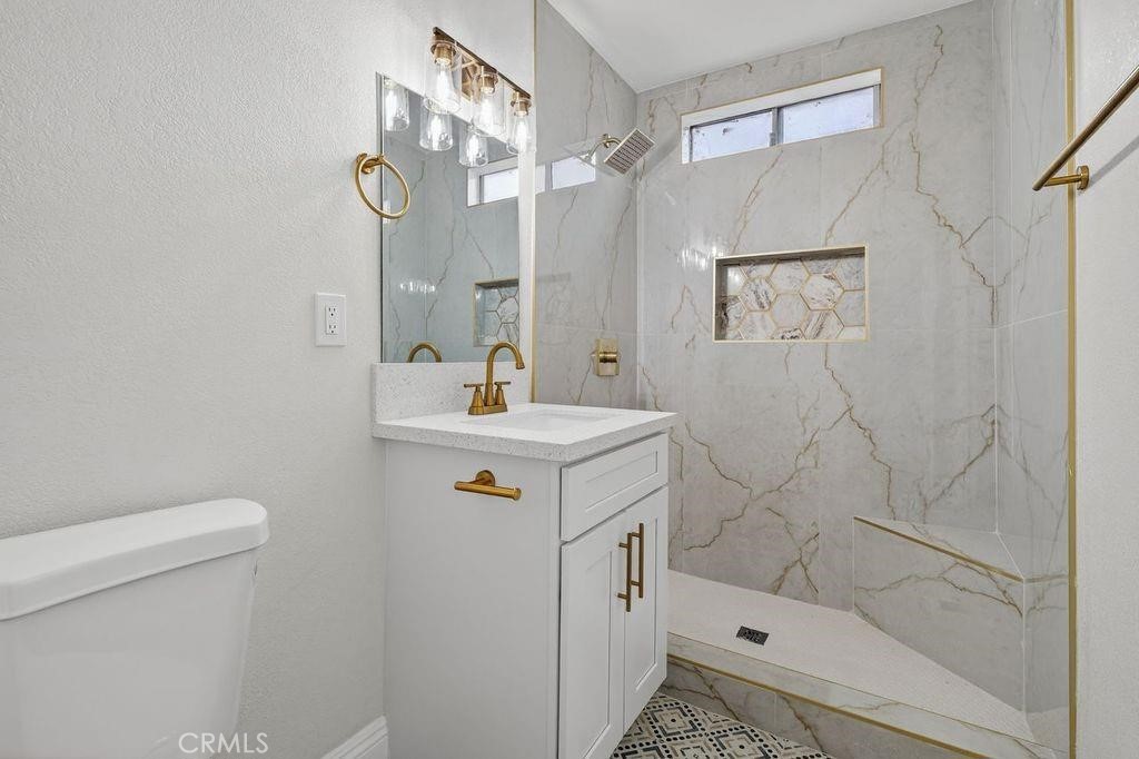 629 South Sage Avenue Rialto, CA 92376 - Photo 11 of 16 a bathroom with a sink a toilet and shower