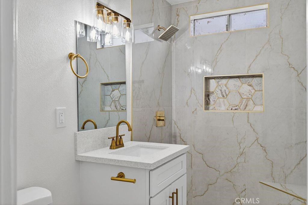 629 South Sage Avenue Rialto, CA 92376 - Photo 12 of 16 a bathroom with a sink vanity and a shower