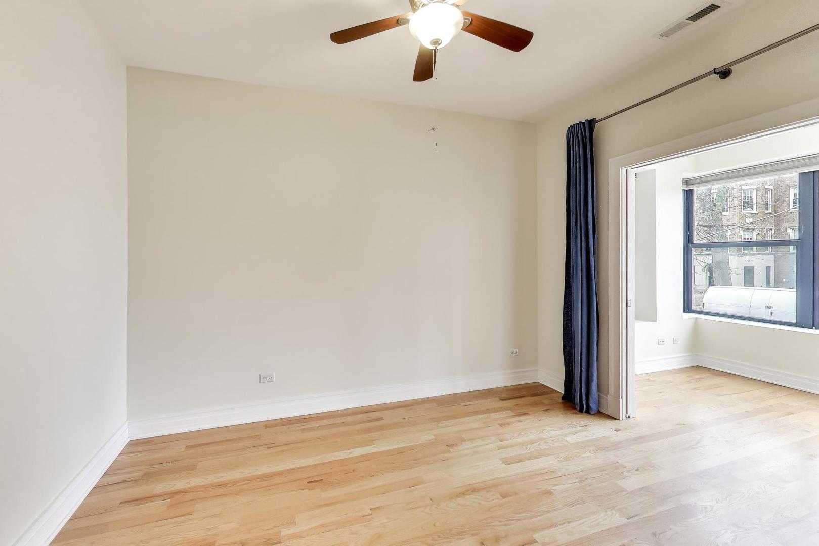 1640 West Fargo Avenue, Unit 101 Chicago, IL 60626 - Photo 12 of 22 an empty room with a empty space and windows