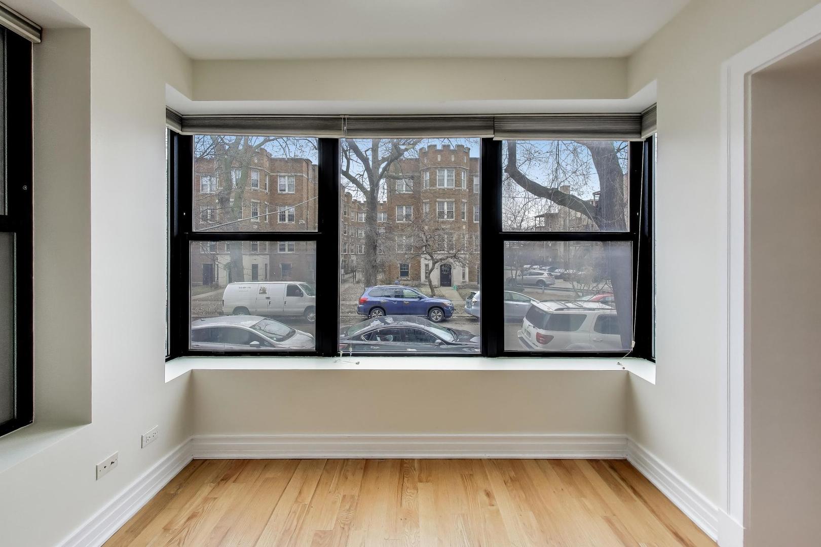 1640 West Fargo Avenue, Unit 101 Chicago, IL 60626 - Photo 14 of 22 a view of empty room with wooden floor and fan