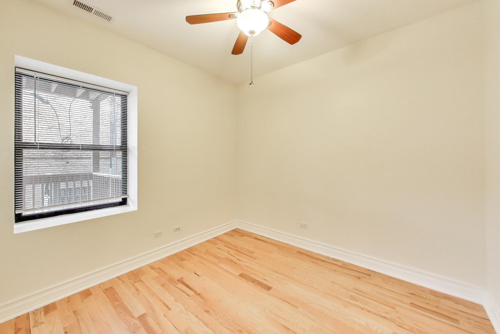1640 West Fargo Avenue, Unit 101 Chicago, IL 60626 - Photo 16 of 22 an empty room with a window and a ceiling fan