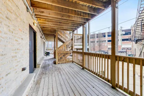 a view of a balcony with wooden floor