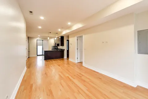 a view of kitchen with refrigerator and window