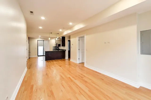 a view of kitchen with refrigerator and window