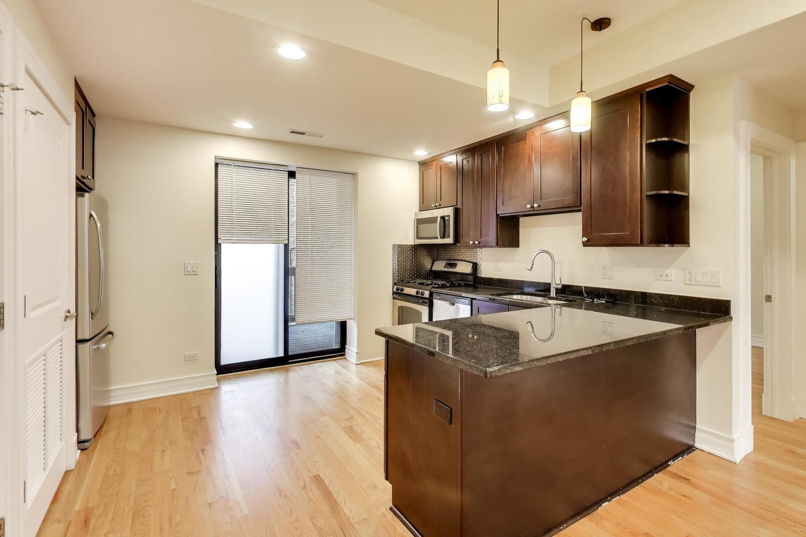 1640 West Fargo Avenue, Unit 101 Chicago, IL 60626 - Photo 8 of 22 a kitchen with granite countertop a sink appliances and cabinets