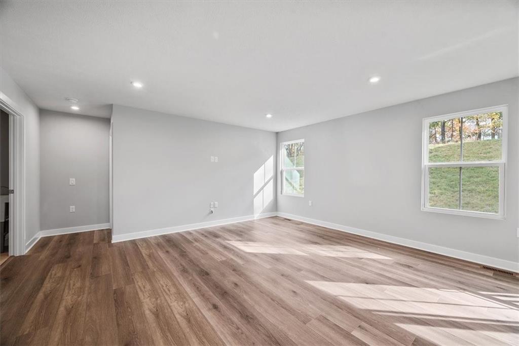 851 Ashley Road Gibsonia, PA 15044 - Photo 18 of 50 a view of an empty room with wooden floor and a window