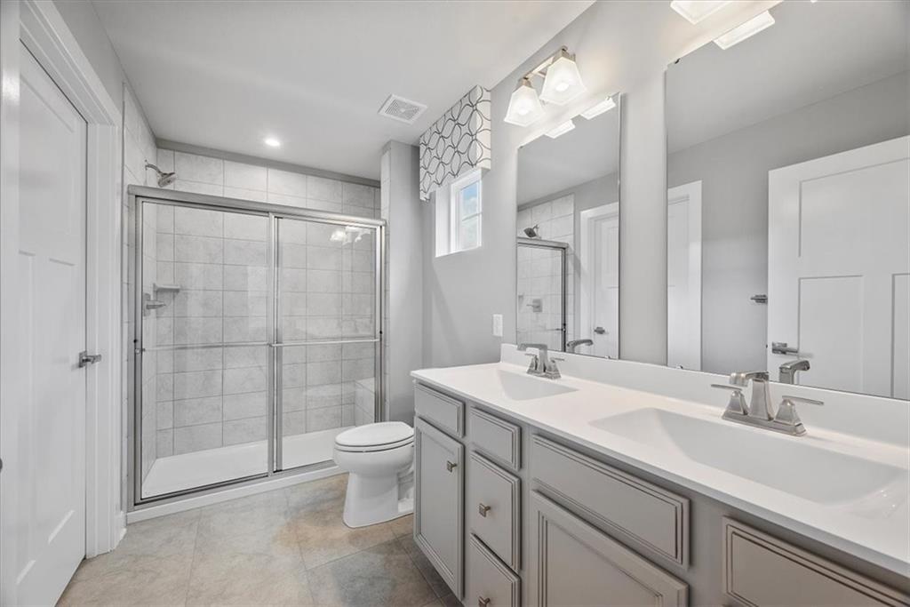 851 Ashley Road Gibsonia, PA 15044 - Photo 32 of 50 a bathroom with a double vanity sink toilet and shower