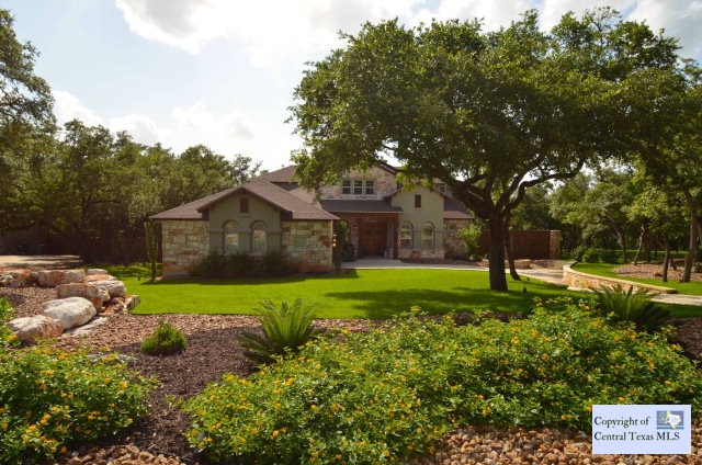 a view of backyard of house with green space