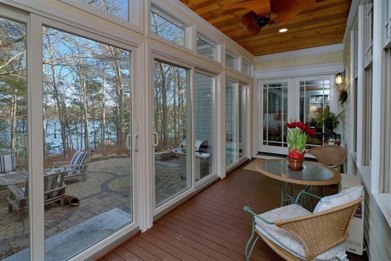 11 Harbor Ridge Road Mashpee, MA 02649 - Photo 17 of 33 a dining room with wooden floor and a floor to ceiling window