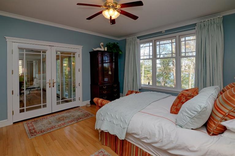 11 Harbor Ridge Road Mashpee, MA 02649 - Photo 23 of 33 a bedroom with a large bed and a chandelier