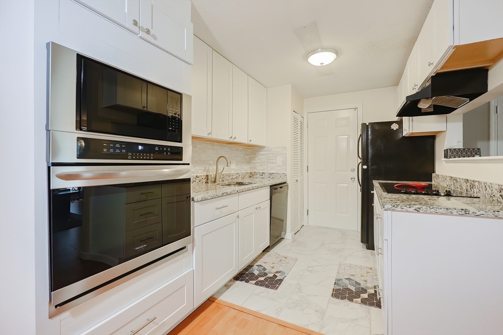 28 Walden Drive, Unit 17 Natick, MA 01760 - Photo 14 of 34 a kitchen with a stove and a microwave