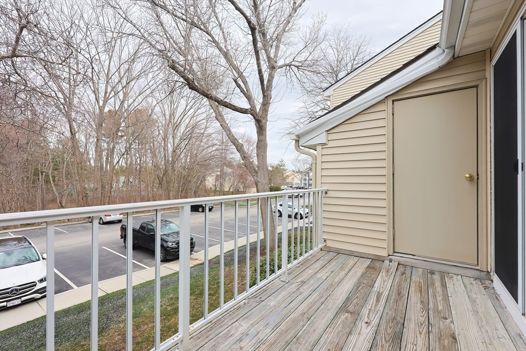 28 Walden Drive, Unit 17 Natick, MA 01760 - Photo 23 of 34 a view of a balcony with wooden floor and fence