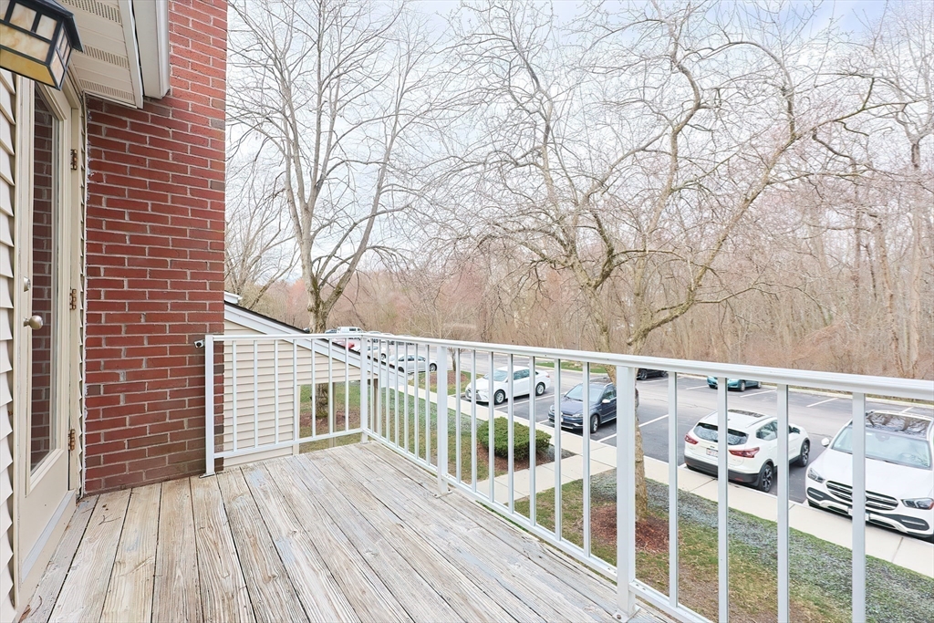 28 Walden Drive, Unit 17 Natick, MA 01760 - Photo 25 of 34 a view of a balcony with wooden floor and fence