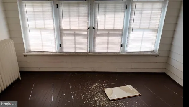 a view of wooden floor and windows in a room