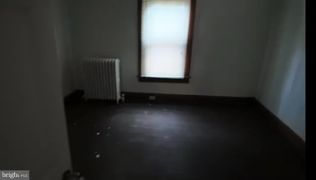 a view of an empty room and wooden floor