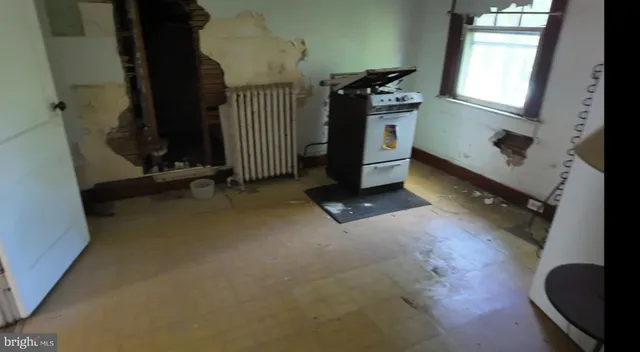 a view of a livingroom with entryway and window