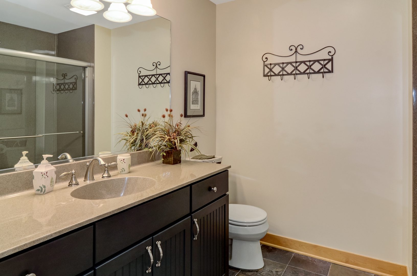 307 North County Line Road Hinsdale, IL 60521 - Photo 27 of 31 a bathroom with a granite countertop sink a toilet and a mirror