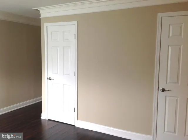 an empty room with wooden floor