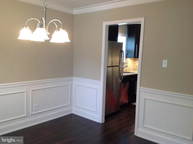 an empty room with wooden floor cabinet and closet